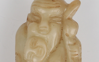A Chinese hardstone pendant, late Qing dynasty, carved in the form of a bearded elder holding a chil