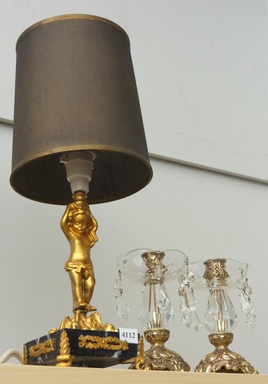 A GILT METAL CHERUB LAMP AND A SIMILAR PAIR OF CANDLE HOLDERS (ONE LUSTRE MISSING)