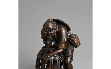 A JAPANESE CARVED WOOD MODEL OF A FISHERMAN, PROBABLY LATE 1...
