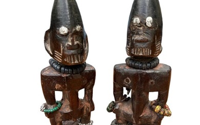 A PAIR OF AFRICAN YORUBA CARVED WOODEN FERTILITY FIGURES Mal...