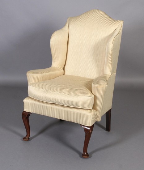 A QUEEN ANNE STYLE MAHOGANY WINGED ARMCHAIR, having an arche...