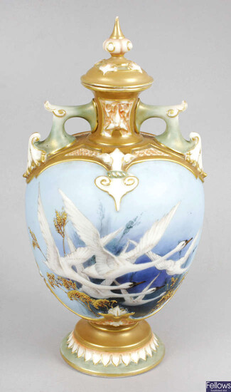 A Royal Worcester bone china vase and cover, decorated with a flight of five swans in the manner of Charlie Baldwin.