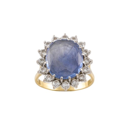 A SAPPHIRE AND DIAMOND CLUSTER RING, the pale oval sapphire ...
