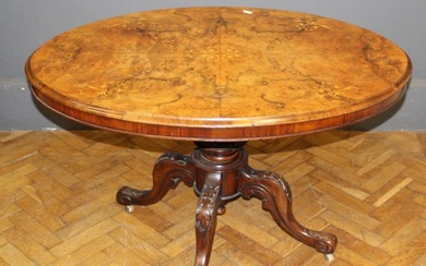 A Victorian walnut and inlaid breakfront table, the snap top...