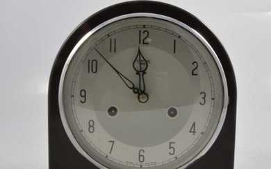 A brown bakelite twin train mantel clock.