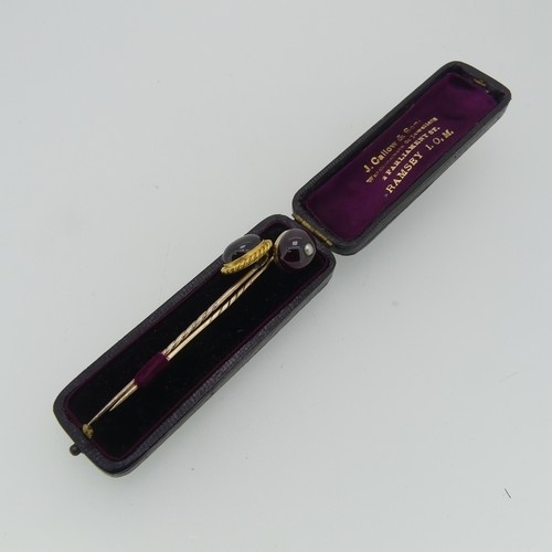 A cabochon amethyst Stick Pin, the oval stone mounted in 18c...