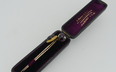A cabochon amethyst Stick Pin, the oval stone mounted in 18c...