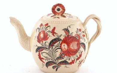 A creamware teapot, 18th century, the body and lid painted with iron red floral decoration, with moulded spout and strapwork handle, 11.5cm high (VAT charged on hammer price)