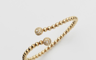A flexible 18k gold and diamond crossover bangle.