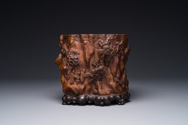 A large Chinese carved huanghuali wooden brush pot with Taoist design, 17/18th C.