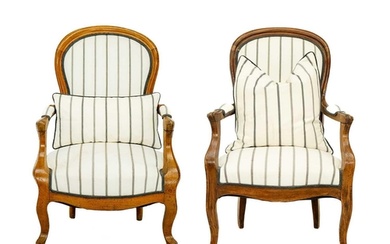A matched pair of French walnut upholstered fauteuil armchai...