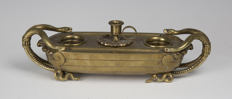 A mid-19th century gilt bronze inkstand, finely cast in the form of a boat with serpent handles, the
