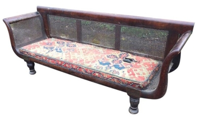 A nineteenth century mahogany sofa with cane panels around...