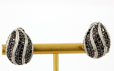 A pair of 18ct white gold teardrop shaped earrings set with black and white diamonds, L. 2cm.