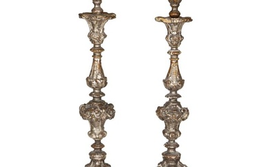 A pair of Continental Baroque silvered gilt candlesticks, 18th century