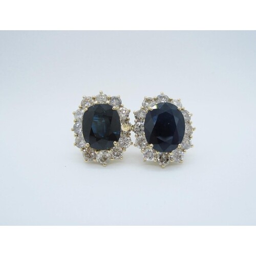 A pair of Sapphire and Diamond Cluster Earrings, each claw-s...