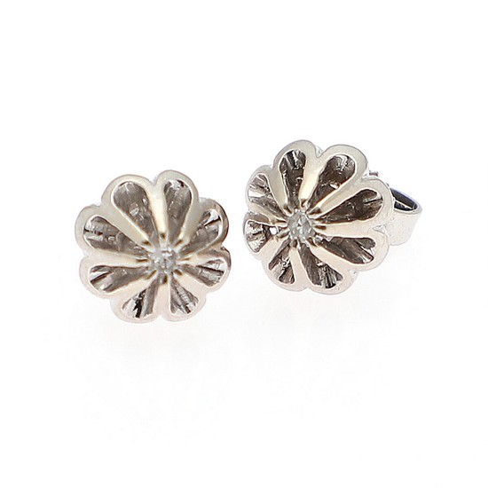 A pair of diamond ear studs each set with a single-cut diamond, mounted in 14k white gold. Diam. 8 mm. (2)