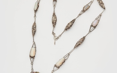 A rare silver gold granule and translucent enamel Arts and Crafts sautoir necklace set with opals, garnets and spinels in the manner of Dorrie Nossiter, ca. 1925.