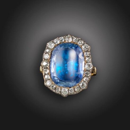 A sapphire and diamond cluster ring, centred with a cushion-shaped...