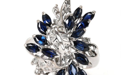 A sapphire and diamond ring set with numerous marquise-cut sapphires and brilliant-cut...