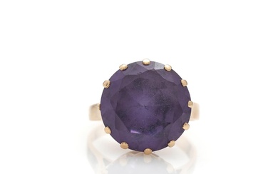 A sapphire ring set with faceted syntetic purple sapphire, mounted in 14k...