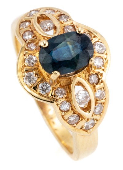 AN 18CT GOLD SAPPHIRE AND DIAMOND RING; centring an approx. 1.00ct blue oval sapphire to surround and open shoulders set with 22 rou...