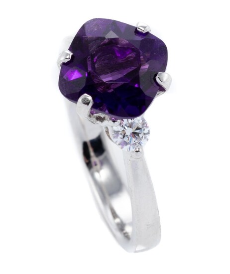 AN 18CT WHITE GOLD AMETHYST AND DIAMOND RING; featuring a cushion cut amethyst between 2 shoulder diamonds totalling 0.20ct, size L.