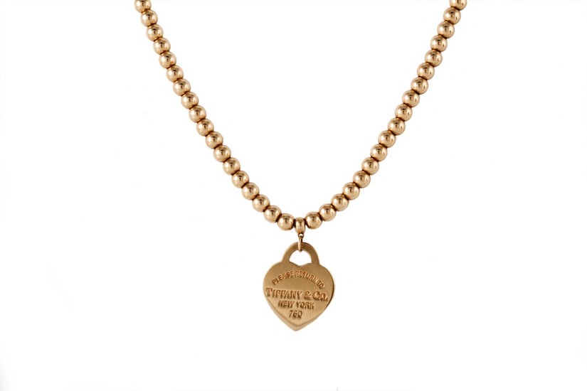 AN 18CT YELLOW GOLD BEADED NECKLACE, with heart pendant, by ...