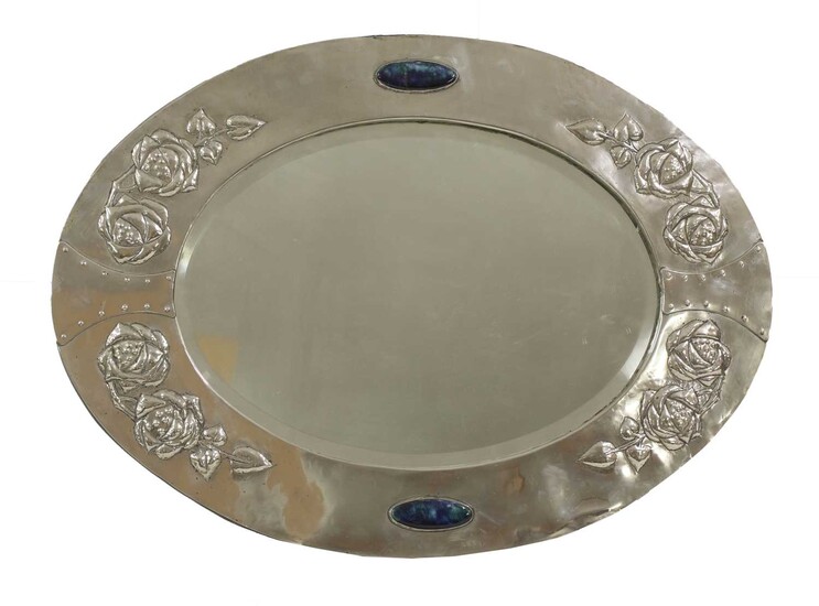 An Arts and Crafts silver-plated oval wall mirror