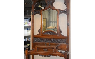 An Edwardian carved mahogany hall stand, with mirror inset b...