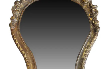 An Italian giltwood and gesso wall mirror, 18th century, the shaped moulded...