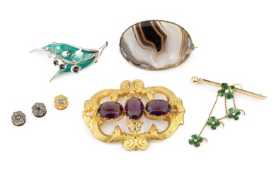 An amethyst brooch, the three oval cut stones within a...