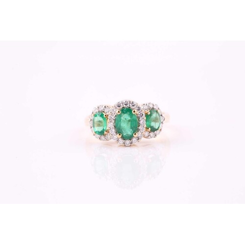 An emerald and diamond three stone ring, oval cut emeralds w...