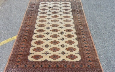 Bokhara carpet, in beige, rug is 8' by 5'3"