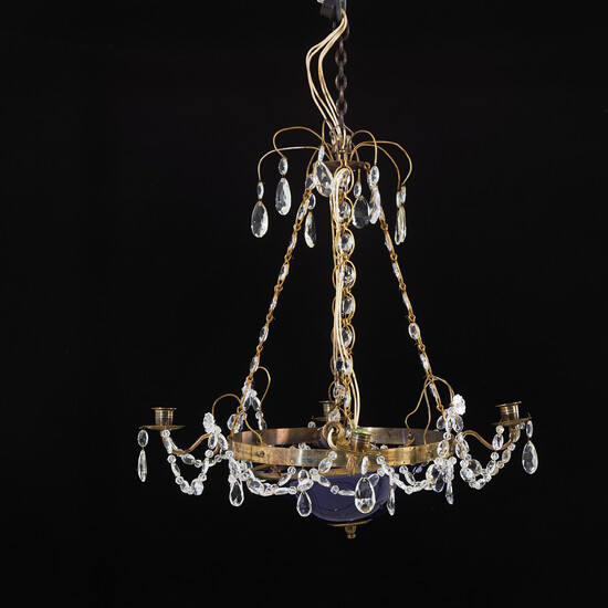 Chandelier, brass frame, first half of the 20th century, differently shaped prisms, lower cup in blue glass, 4 candle arms.