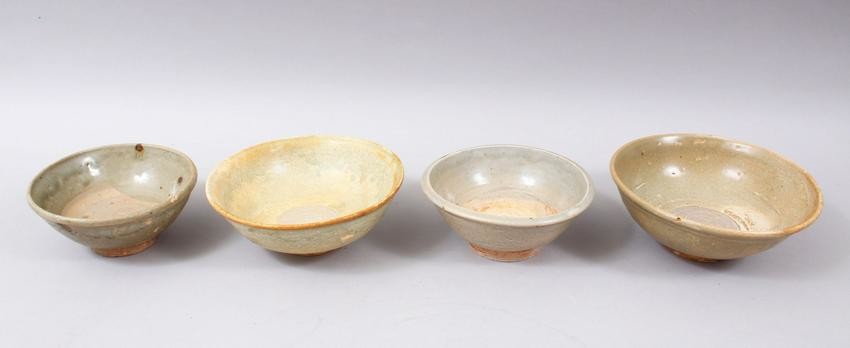 FOUR EARLY CHINESE POTTERY GLAZED BOWLS, some glazed