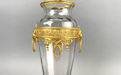Faceted glass vase enriched with a gilded metal...