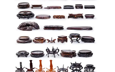 Forty-five Chinese wood stands 19th-20th century Of various shapes and forms, the...