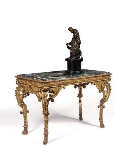 Gilded wood middle table, with openwork decoration (all sides) of foliage and garlands, canals, trellises and palmettes, resting on console legs ending in hooves. Early 18th century, circa 1720, H: 76 cm, W: 108 cm, D: 59 cm Provenance: Former...