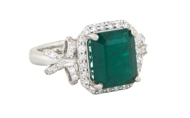 Lady's Platinum Emerald and Diamond Dinner Ring, with a 5.34 carat octagonal emerald atop a border