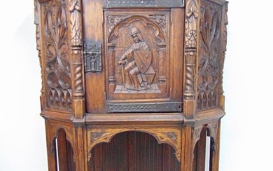 Oak Gothic revival cabinet, carved linenfold sides, knight figure carved in center door flanked by