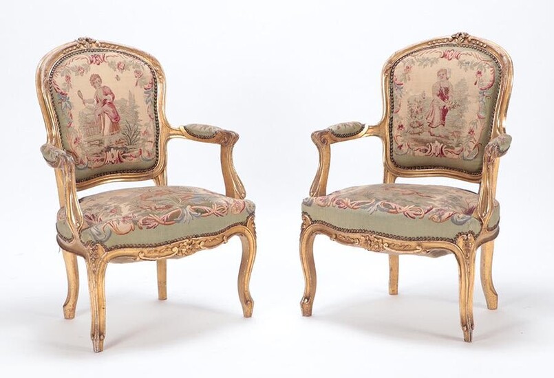 PAIR LOUIS XV STYLE CARVED AND GILT WOOD OPEN ARM CHAIRS C 1900.