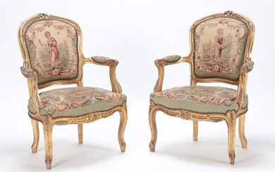PAIR LOUIS XV STYLE CARVED AND GILT WOOD OPEN ARM CHAIRS C 1900.