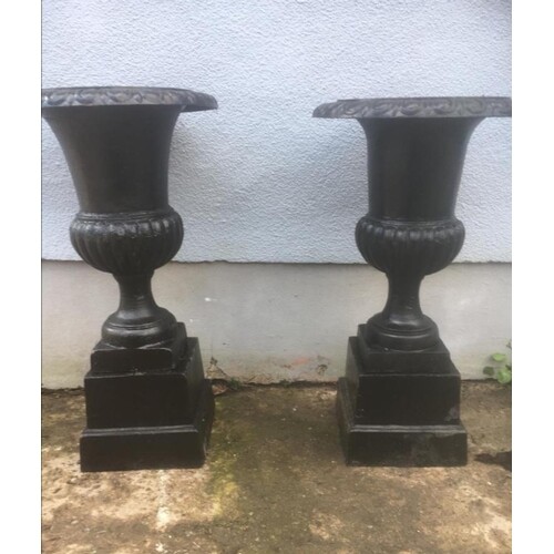 Pair of cast iron garden urns on stands. { 122cm H }.