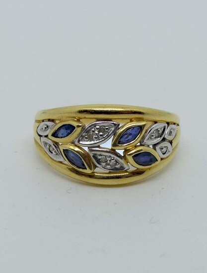 RING openworked in two golds, set with small shuttle sapphires and diamond chips. Gross weight 3.4 g.