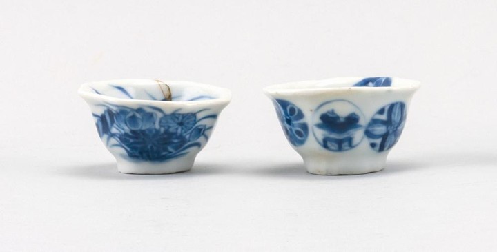 TWO MINIATURE CHINESE BLUE AND WHITE PORCELAIN BOWLS One with lotus flower design, and the other with pinwheel mons. Both wiht shape...