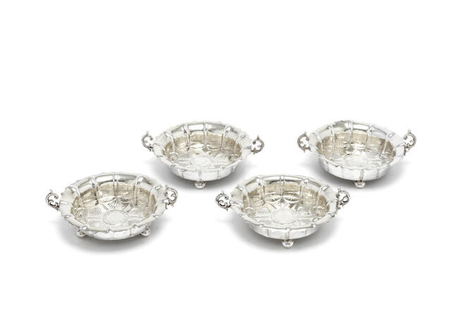 An unsual set of four coin-set silver dishes