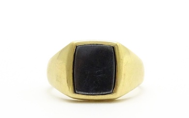 A 9ct gold gentleman's signet ring set with haematite. Ring ...