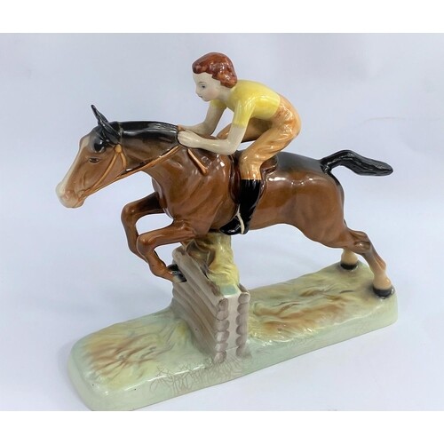 A Beswick group of girl on jumping horse 939, length 26cm (t...