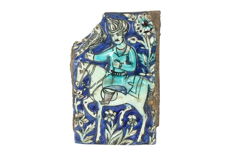 A FRAGMENTARY MOULDED QAJAR POTTERY TILE Late Qajar Iran, late 19th/20th century